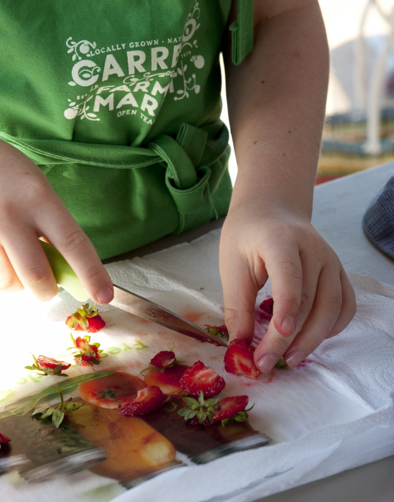 Slicing fresh strawberries at the Carrboro Farmers' Market Cooking Class, May 2015. Photo by Casey Boone. Please contact for permission to reproduce. www.caseyboonephoto.com