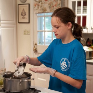 Adding local onions and pasture raised bacon to the black beans. Image by CaseyBoonePhotography.com. All rights reserved